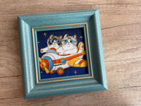 Two-cat portrait example with an aeroplane scene and fine outlined detail in a blue frame