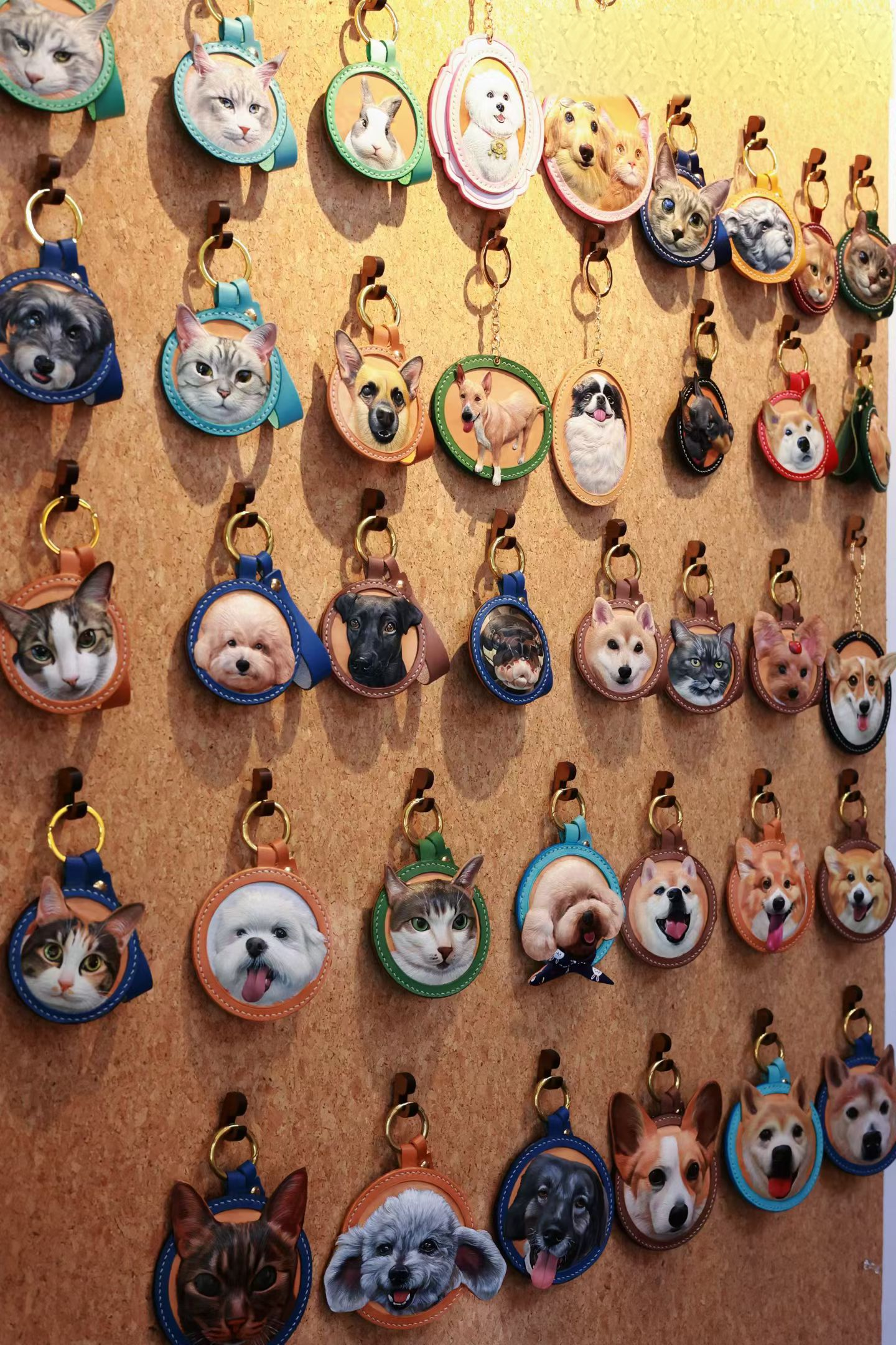 Close view of a cat and dog double portrait on one round leather base in the workshop