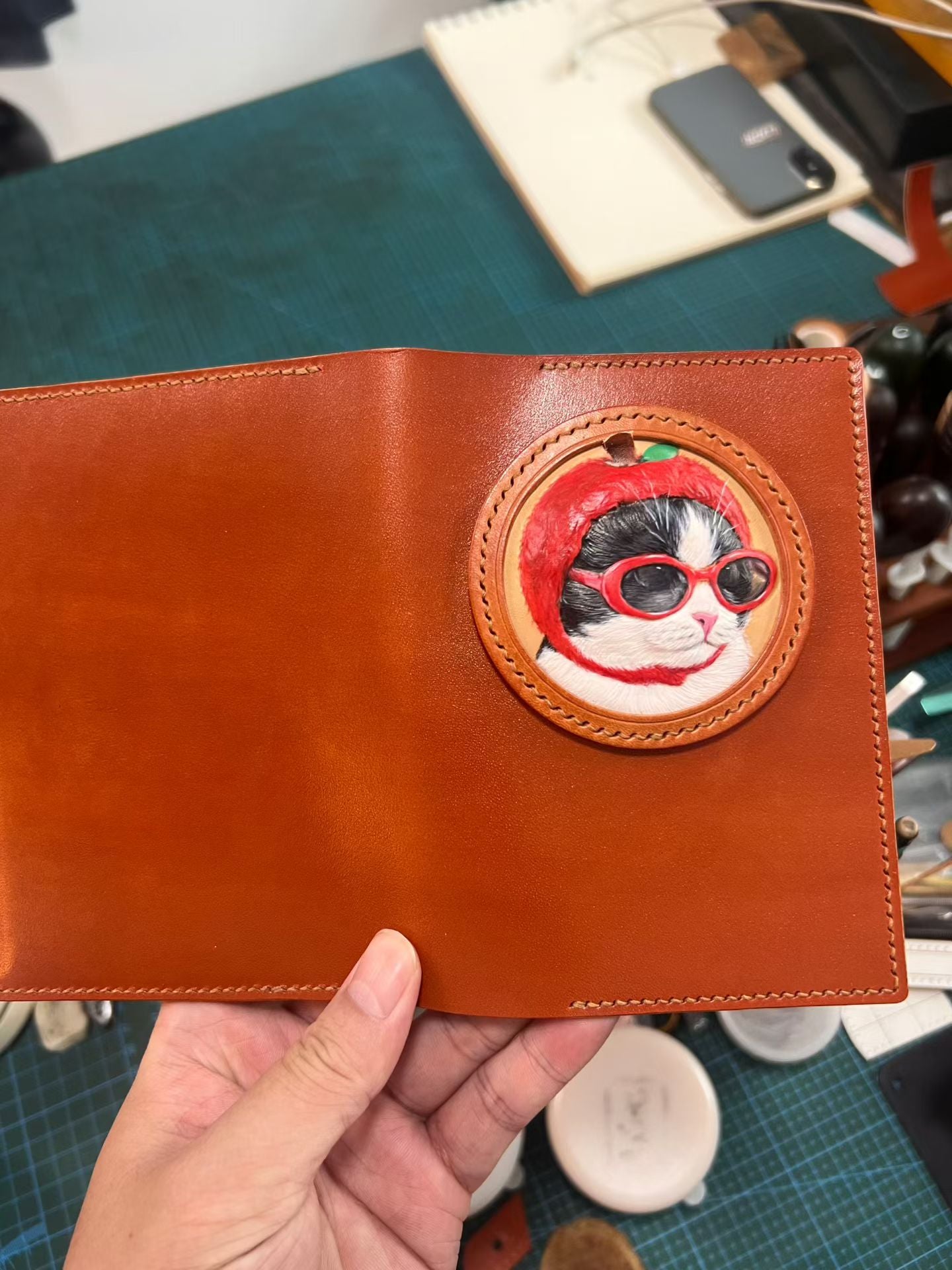 Supplier photograph of an open orange leather passport cover with a dog portrait.